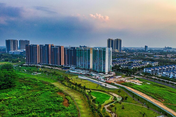 tall-glass-buildings-near-green-grass-field-photo_195114-13339